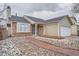 Charming exterior of home featuring a brick and beige color scheme and well-maintained landscaping at 19558 E Purdue Pl, Aurora, CO 80013