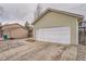 Detached garage features a white door, beige siding, and convenient driveway access at 19558 E Purdue Pl, Aurora, CO 80013