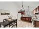 Kitchen with dark wood cabinets, white appliances, tile floors, and an adjacent dining area at 19558 E Purdue Pl, Aurora, CO 80013