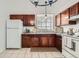 Kitchen with granite countertops, tile floor, and wood cabinets at 19558 E Purdue Pl, Aurora, CO 80013