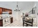 Bright kitchen featuring tile floors, white appliances, and adjacent dining area at 19558 E Purdue Pl, Aurora, CO 80013