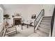Bright living room featuring a tiled fireplace, vaulted ceilings, carpeted floors, and staircase to the second floor at 19558 E Purdue Pl, Aurora, CO 80013