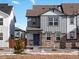 Two-story home with gray siding, stone accents, and a welcoming front porch at 249 Mayfly Ln, Berthoud, CO 80513