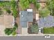 Overhead view of a home with a gray roof, surrounded by other houses, garages, and mature trees at 6337 W 68Th Pl, Arvada, CO 80003