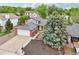 Aerial view of a house with a gray roof, brick foundation, and a well-maintained driveway at 6337 W 68Th Pl, Arvada, CO 80003