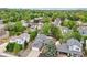 Aerial view of a home nestled in a neighborhood with lush greenery and mature trees at 6337 W 68Th Pl, Arvada, CO 80003