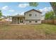 Backyard of a gray two-story home, featuring a covered patio and fenced yard with trees at 6337 W 68Th Pl, Arvada, CO 80003