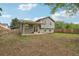 View of the house's backyard with a covered patio and wooden fence, partially bare ground at 6337 W 68Th Pl, Arvada, CO 80003