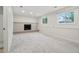 This finished basement has new carpet, a fireplace with brick surround, and egress windows for natural light at 6337 W 68Th Pl, Arvada, CO 80003