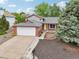 Charming single-Gathering home featuring a well-maintained yard, attached garage and inviting front door at 6337 W 68Th Pl, Arvada, CO 80003