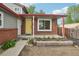 This property features a brick porch with a yellow door and a garden perfect for enjoying sunny afternoons at 6337 W 68Th Pl, Arvada, CO 80003