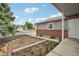 Charming home featuring a brick foundation, landscaped front yard, and a covered porch at 6337 W 68Th Pl, Arvada, CO 80003
