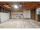 Spacious garage with exposed wood beams, concrete floor, and shelving for storage at 6337 W 68Th Pl, Arvada, CO 80003