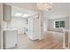 Bright, updated kitchen with white appliances, skylight, and seamless flow into the open floor plan at 6337 W 68Th Pl, Arvada, CO 80003