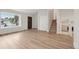 Bright living room with hardwood floors, large windows, and open staircase at 6337 W 68Th Pl, Arvada, CO 80003