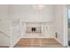 Upper-level view of open floor plan to living room with fireplace and lots of light at 6337 W 68Th Pl, Arvada, CO 80003
