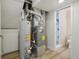 Utility room with new hot water tank, furnace, and access to updated bathroom at 6337 W 68Th Pl, Arvada, CO 80003
