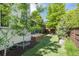 This backyard features lush landscaping, a small deck and a shed at 2899 Emporia Ct, Denver, CO 80238