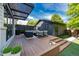 Outdoor living space featuring a large deck, modern pergola, and stylish furniture perfect for entertaining at 2899 Emporia Ct, Denver, CO 80238