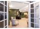 Open glass doors lead into this cozy basement with sitting area, fireplace and piano at 2899 Emporia Ct, Denver, CO 80238