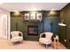 The finished basement features built in storage, a fireplace and two chairs at 2899 Emporia Ct, Denver, CO 80238