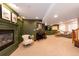 A finished basement area with a fireplace, seating, and carpeted floors at 2899 Emporia Ct, Denver, CO 80238