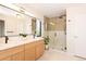 Bright bathroom featuring double vanity, modern fixtures, spacious walk-in shower with elegant tile, and contemporary design at 2899 Emporia Ct, Denver, CO 80238
