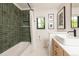 This bathroom features a tiled wall shower, white honeycomb floor tiles and black framed mirror at 2899 Emporia Ct, Denver, CO 80238