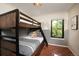 bedroom featuring bunk beds, neutral color palette and window view at 2899 Emporia Ct, Denver, CO 80238