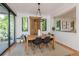 Bright dining area with a wooden table, stylish black chairs, and modern lighting at 2899 Emporia Ct, Denver, CO 80238