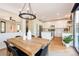 Open-concept dining area adjacent to the kitchen with stylish chandelier and modern decor at 2899 Emporia Ct, Denver, CO 80238