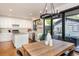 Bright dining area with wood table and view of the backyard through glass doors at 2899 Emporia Ct, Denver, CO 80238