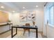 A bright home office area with neutral colors and simple furniture at 2899 Emporia Ct, Denver, CO 80238
