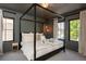 Stylish main bedroom showcasing a four-poster bed, elegant lighting, and serene ambiance with natural light at 2899 Emporia Ct, Denver, CO 80238