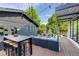 Spacious patio offers an outdoor dining area, comfortable lounge seating, and lush greenery, perfect for entertaining at 2899 Emporia Ct, Denver, CO 80238