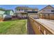View of home's backyard showing the deck and pergola at 375 Longspur Dr, Brighton, CO 80601