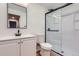 Modern bathroom featuring a sleek vanity, toilet, and a glass-enclosed shower with matte black hardware at 375 Longspur Dr, Brighton, CO 80601