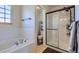 Bathroom featuring soaking tub, walk-in shower, and tile flooring at 375 Longspur Dr, Brighton, CO 80601
