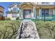 Inviting home featuring a welcoming front porch, well-kept lawn, and a charming walkway at 375 Longspur Dr, Brighton, CO 80601