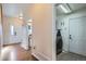 Bright hallway with hardwood floors and access to a laundry room featuring a modern washing machine at 375 Longspur Dr, Brighton, CO 80601