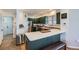 Stylish kitchen featuring green cabinets, stainless steel appliances, and a bright white countertop at 375 Longspur Dr, Brighton, CO 80601