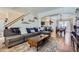Cozy living room with a comfortable couch, wood floors, and open access to the dining area and kitchen at 375 Longspur Dr, Brighton, CO 80601