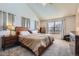 Bright main bedroom showcasing vaulted ceiling, neutral paint, and plush carpet at 375 Longspur Dr, Brighton, CO 80601