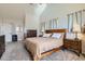 Bright main bedroom showcasing vaulted ceiling, neutral paint, and plush carpet at 375 Longspur Dr, Brighton, CO 80601
