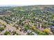 Overhead view of a suburban neighborhood filled with trees and the house centered with an arrow on the roof at 960 S Arbutus St, Lakewood, CO 80228