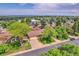 Bird's eye view of home with a manicured lawn, mature trees, long driveway, and a 'For Sale' sign at 960 S Arbutus St, Lakewood, CO 80228