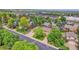 Aerial view of a suburban neighborhood with tree lined streets, and the house centered with an arrow on the property at 960 S Arbutus St, Lakewood, CO 80228