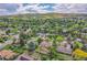 Aerial view of a suburban neighborhood with lush greenery and the house centered with an arrow on the roof at 960 S Arbutus St, Lakewood, CO 80228