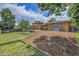 Expansive backyard featuring garden beds, wood mulch, and patio at 960 S Arbutus St, Lakewood, CO 80228