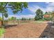 Spacious backyard with wood chip area, wood fence, and grassy area in the back at 960 S Arbutus St, Lakewood, CO 80228